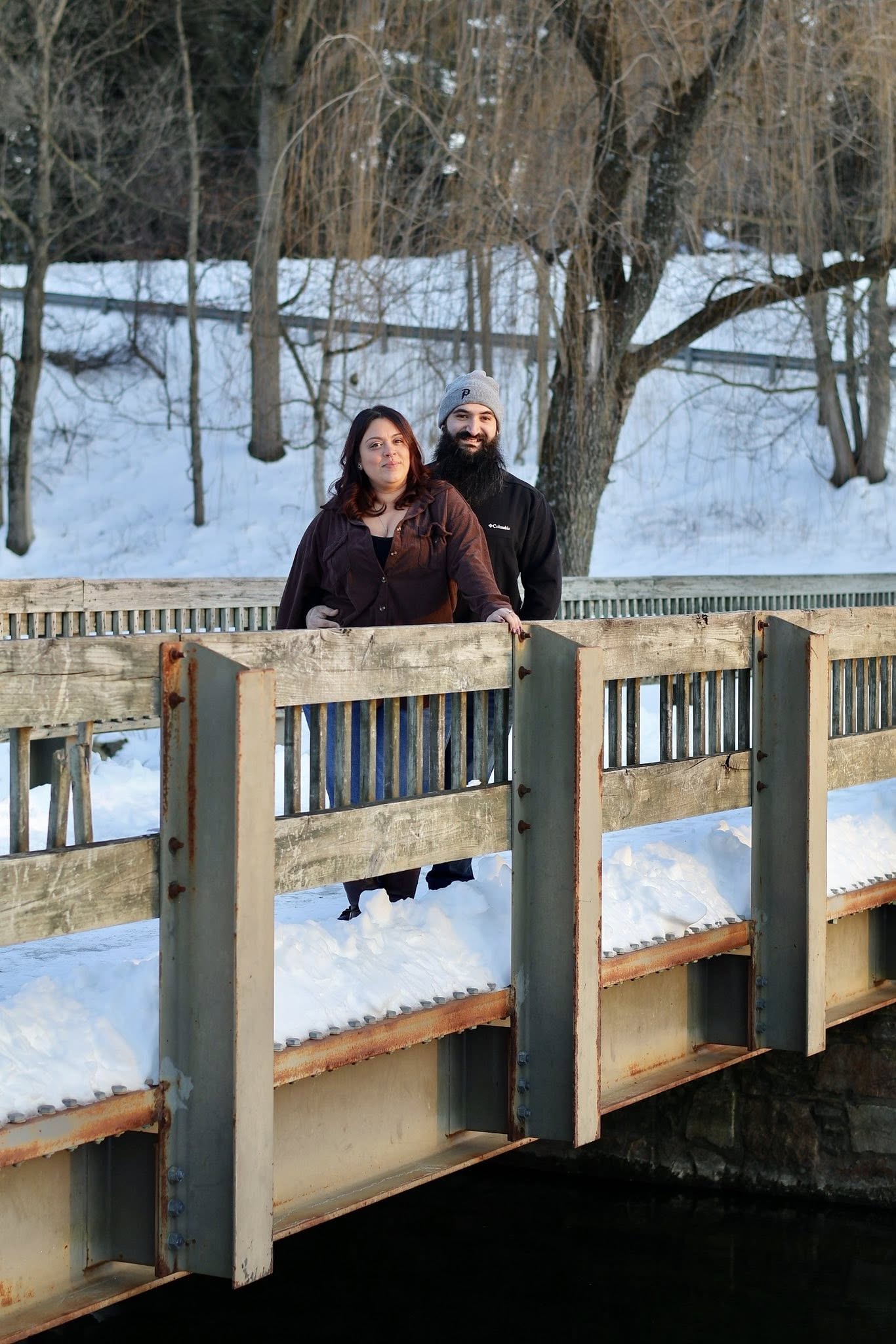 Couple on a snowy bridge