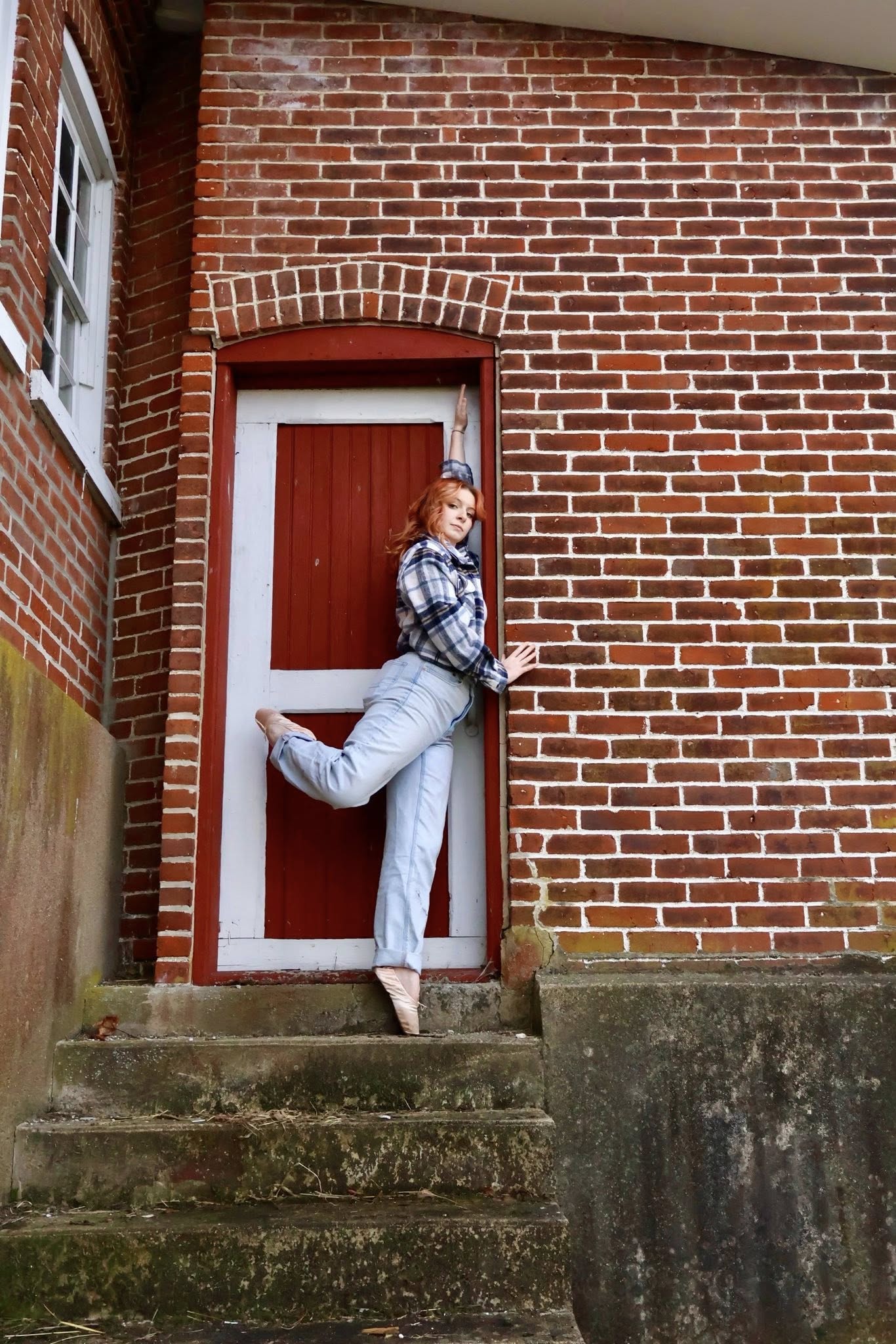 Ballet pose at a red brick door