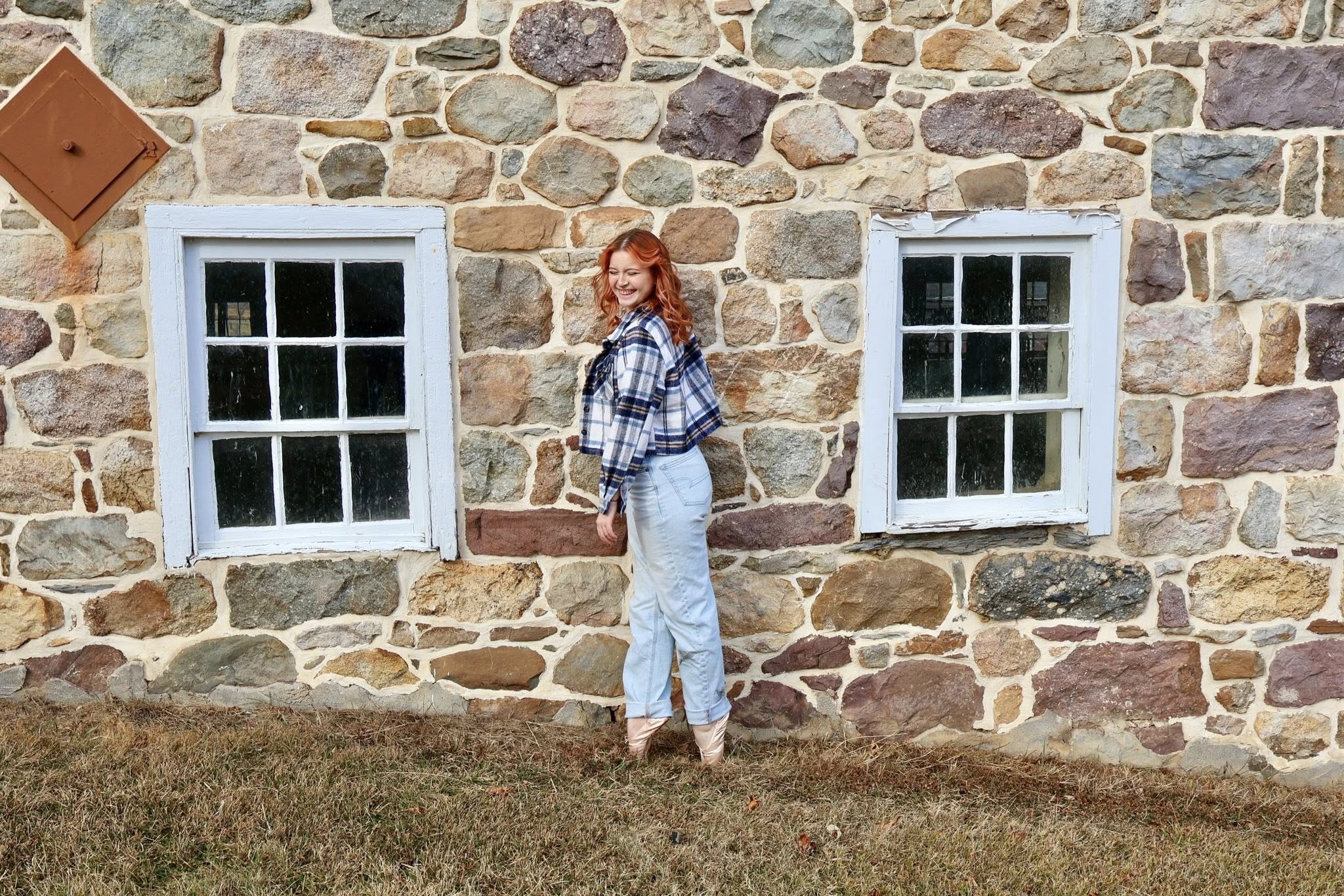 Senior portrait at a stone wall