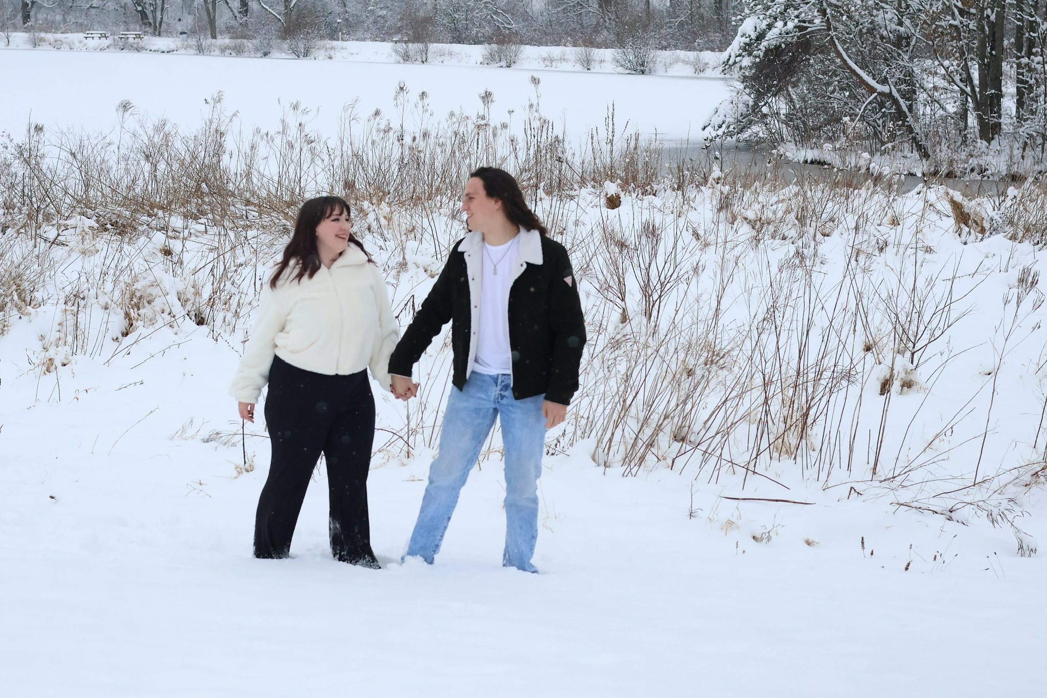 Couple holding hands in the snow